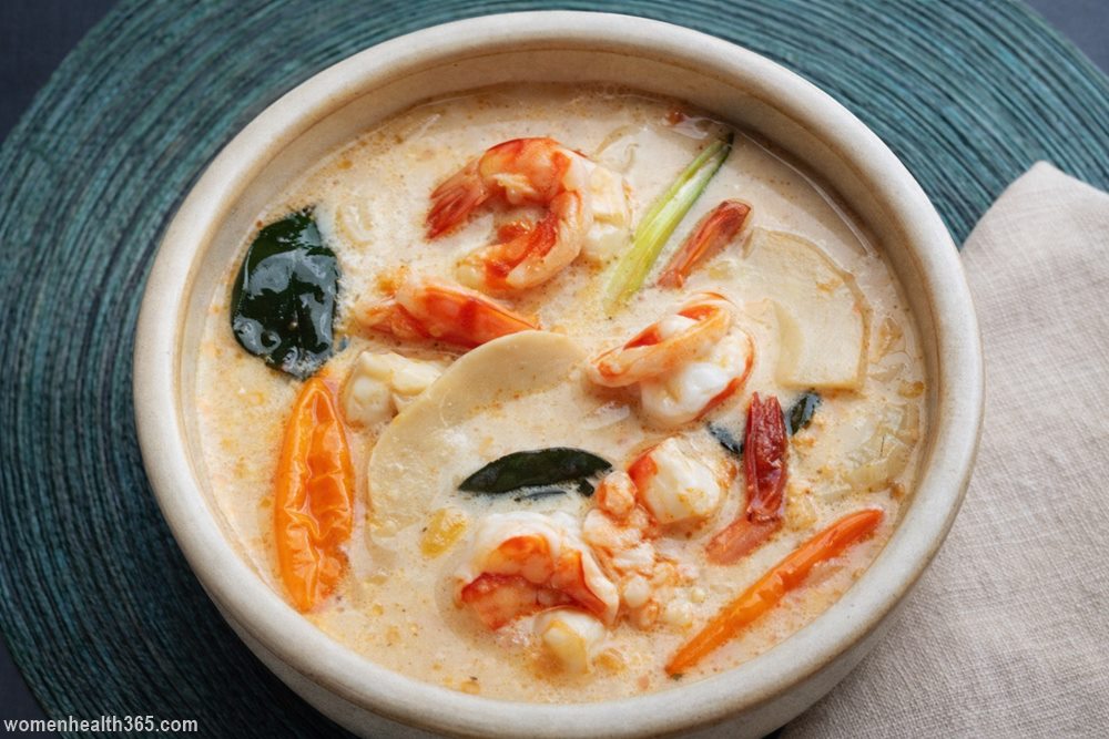 Thai Prowns in Coconut Milk soup with shrimp, coconut milk broth, herbs, and chili served in a bowl